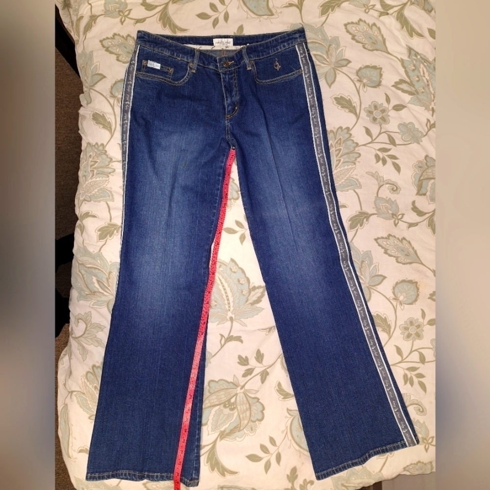 A pair of Baby Phat blue flare leg jeans in a size 13. Waist is 16.5, 29 inseam